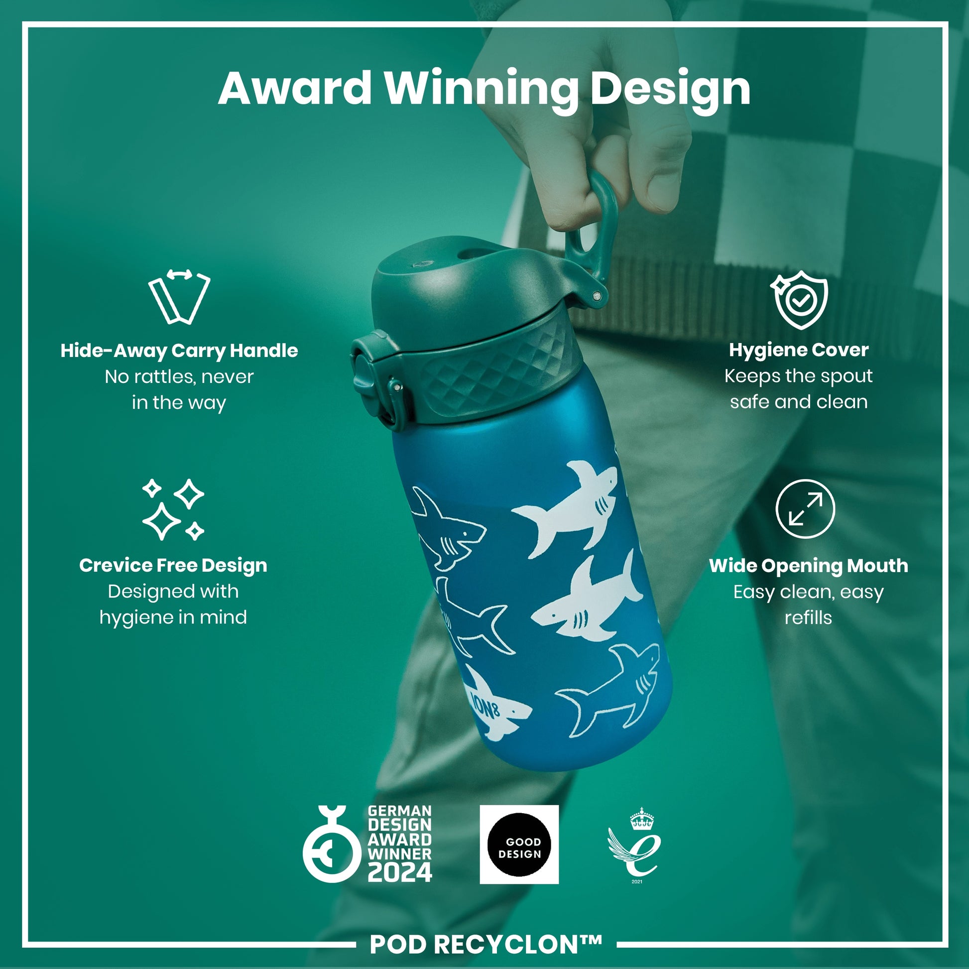 A blue water bottle, with a teal lid and sharks printed on it, is being held. It features a hide-away handle, hygiene cover, and wide mouth. The bottle is an award-winning design.