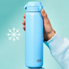 A light blue ION8 water bottle is held against a teal background. The bottle is being held by a person wearing a light blue sweatshirt.
