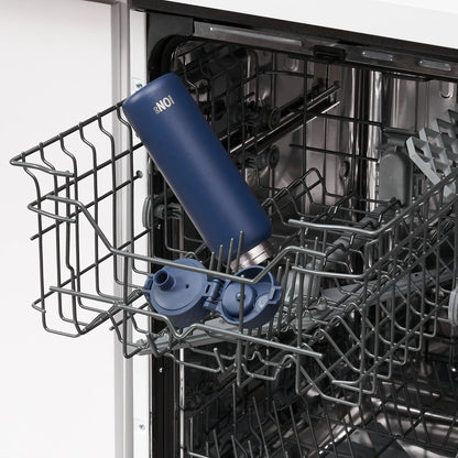 A blue water bottle with the text "ION8" placed on the top rack inside an open dishwasher in a kitchen setting.