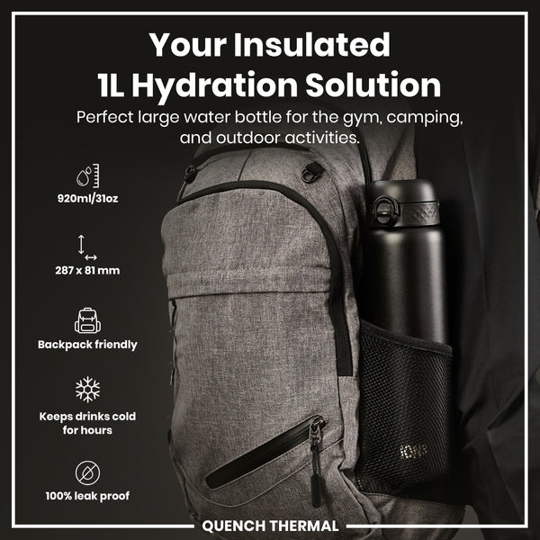 A black, insulated water bottle fits inside a gray backpack's mesh pocket; it's designed for gym, camping, and outdoor use. 920ml/31oz; 287 x 81 mm; backpack friendly; keeps drinks cold for hours; 100% leak proof. QUENCH THERMAL.