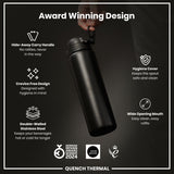 A black, double-walled stainless steel water bottle is being held; it features a hide-away handle, wide mouth, and hygiene cover. The bottle is shown against a dark background, and boasts several design awards.