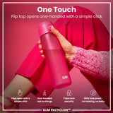 A pink water bottle is being held; its flip top is opened with one hand. The context is a pink background and clothing. One Touch. Flip top opens one-handed with a simple click. Flips open with a simple click. One-handed use on the go. Triple lock security. 100% leak proof - no twisting, no leaks. SLIM RECYCLON™.