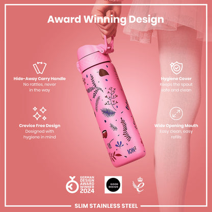 A pink water bottle with floral print is being held; it features a hide-away handle, hygiene cover, and wide mouth opening. The bottle is an award-winning design, made of slim stainless steel.
