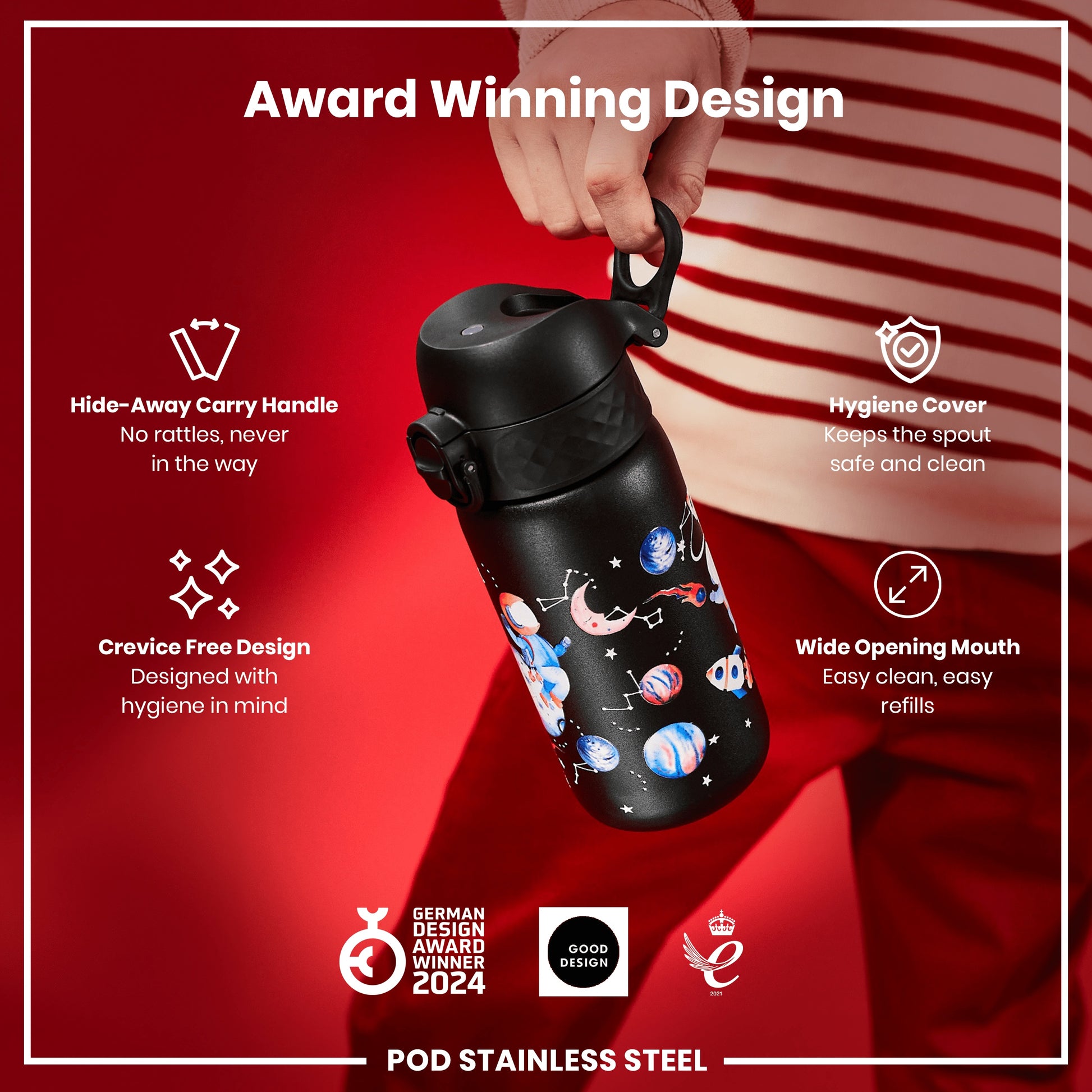 A black water bottle with a space theme design is being held; it features a hide-away handle and a wide mouth for easy cleaning, against a red background. The bottle boasts award-winning design and hygiene features.