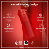 A red water bottle is being held; it features a hide-away handle, hygiene cover, and wide mouth. The bottle is award-winning, designed for hygiene, and labeled 