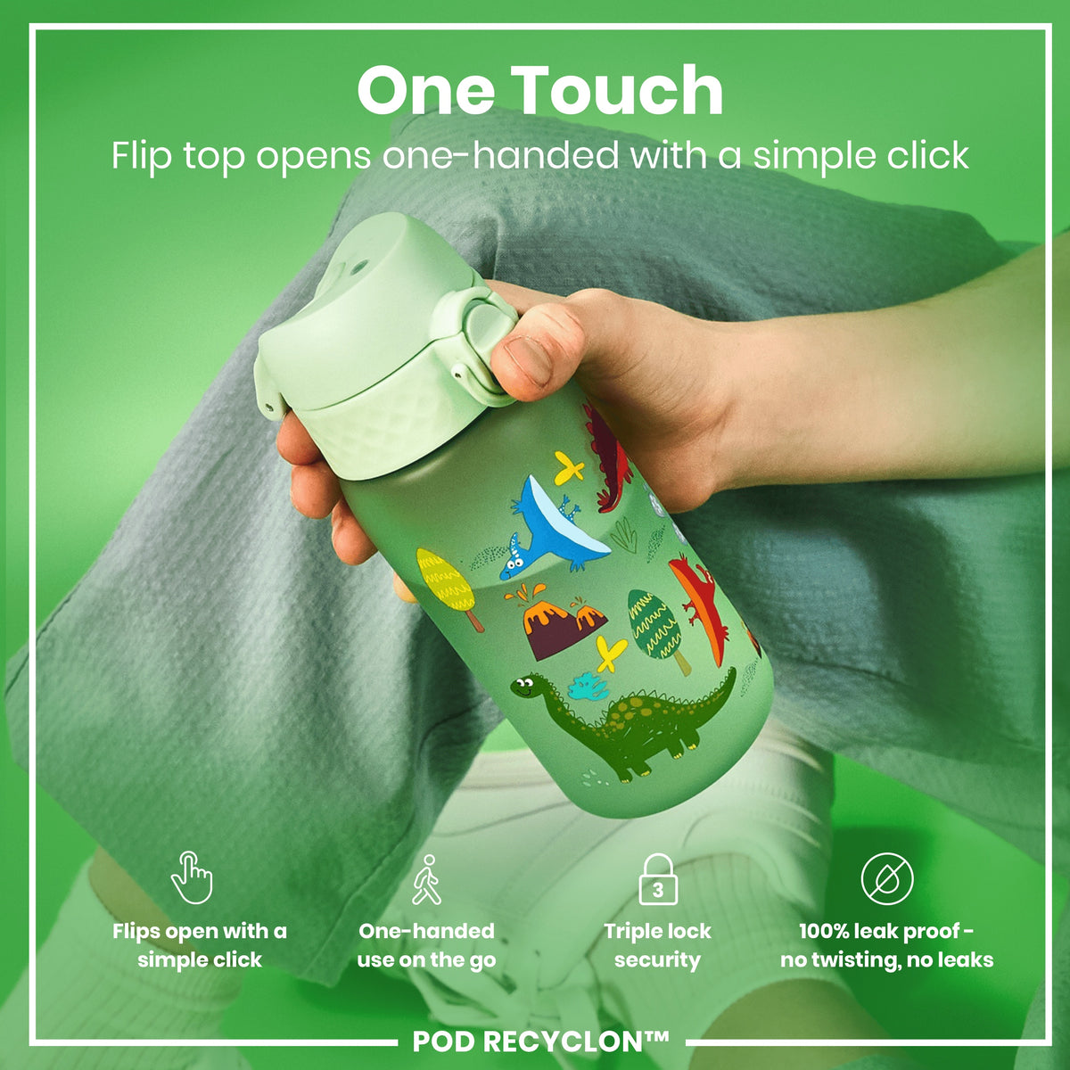 A light green water bottle, featuring dinosaur illustrations, is being held. Its flip top opens one-handed; it’s leak-proof and has triple lock security. The bottle is shown against a green backdrop.