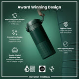 A dark-green, double-walled stainless steel thermal bottle is being held; its features are highlighted against a green background. Award Winning Design.