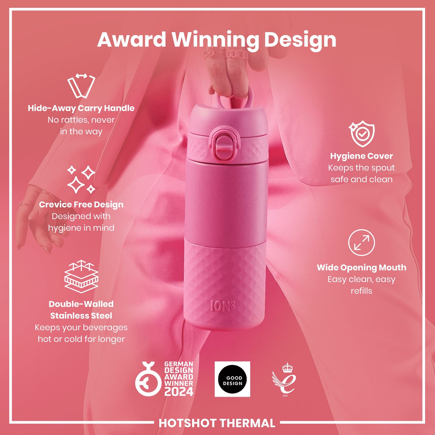 A pink, double-walled stainless steel water bottle is being held; it features a hide-away handle, crevice-free design, hygiene cover, and wide opening mouth. The bottle is award-winning.