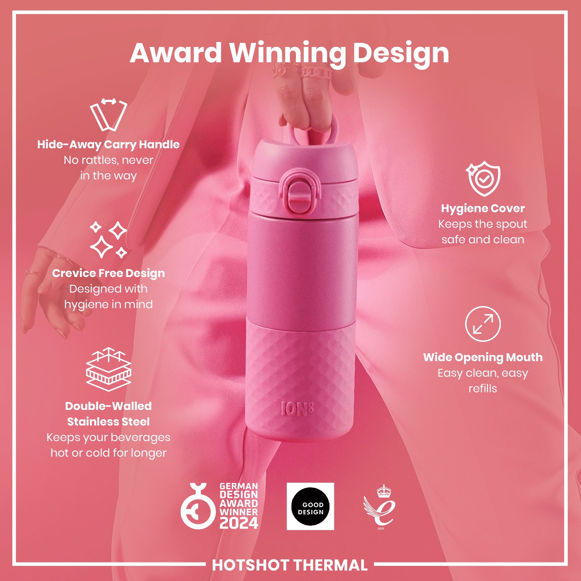 A pink, double-walled stainless steel water bottle is being held; it features a hide-away handle, crevice-free design, hygiene cover, and wide opening mouth. The bottle is award-winning.