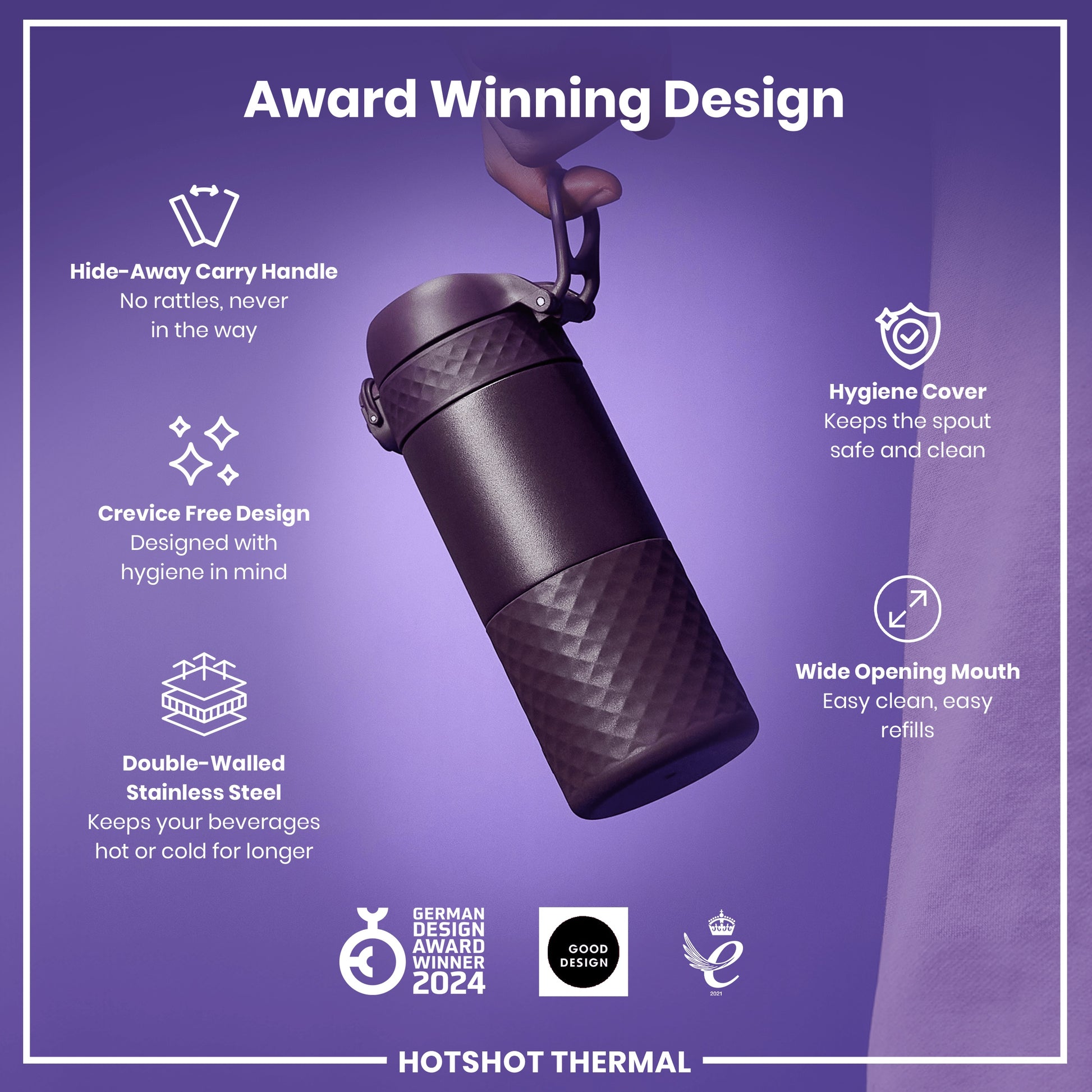 A dark-purple, double-walled stainless steel thermos is being held. It features a hide-away carry handle, crevice-free design, hygiene cover, and wide mouth. The thermos keeps beverages hot or cold longer and is an award-winning design.