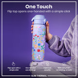 A purple floral water bottle is being held; its flip top opens easily with one hand. The bottle is shown against a purple background. 