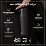 A dark-grey water bottle is being held; it has a handle and straw. The bottle features a wide mouth and hygiene cover. Awards and design details are shown on the accompanying advertisement.