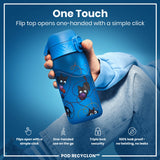 A blue water bottle, featuring a flip top, is being held. The top opens one-handed. It's illustrated with playful kittens and yarn, against a blurred background. 