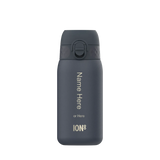 A dark gray water bottle stands upright featuring a flip-top lid and customization text: 