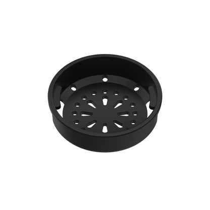 A round black drip tray with multiple perforations sits isolated against a plain white background.