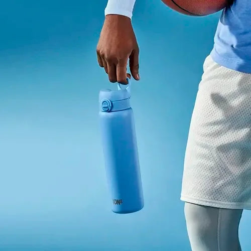image of basket ball player holding a blue stainless steel ion8 water bottle